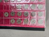 a display case with a lot of silver coins in it