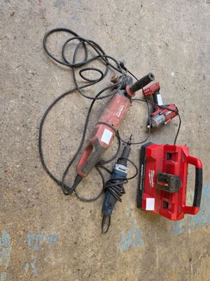 une perceuse filaire et une autre perceuse filaire posées par terre