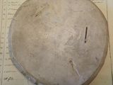 an old drum sitting on top of a piece of paper