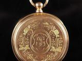 an image of a gold pocket watch on a black background