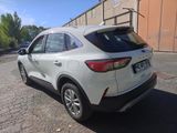 the rear end of a white suv parked on the side of a road