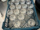many empty wine glasses in a blue crate