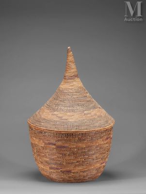 a large woven basket with a lid on a grey background