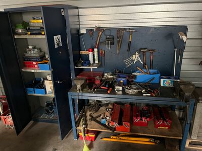 a workbench with tools on it in a garage