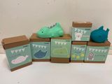many boxes with little animals on them on a table