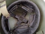 a close up of a military helmet with a metal buckle
