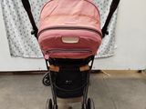 an image of a baby stroller with a pink cover
