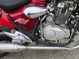 a red motorcycle parked on the side of the road