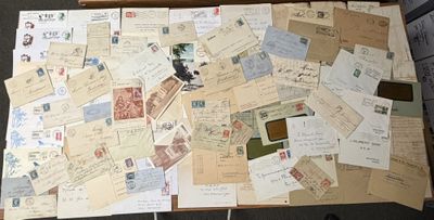 a box full of old letters and stamps on the floor