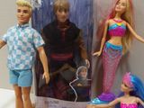 three barbie dolls that are sitting on a table