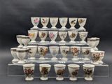 a lot of cups that are sitting on a clear shelf