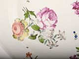 a plate with flowers painted on it on a table