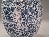 a blue and white vase sitting on a table