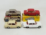 four toy cars are sitting in a row on a white surface