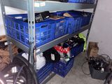 many blue crates stacked on top of each other in a garage