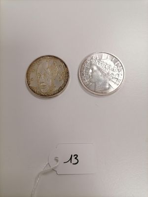 two coins that are on a table with a price tag