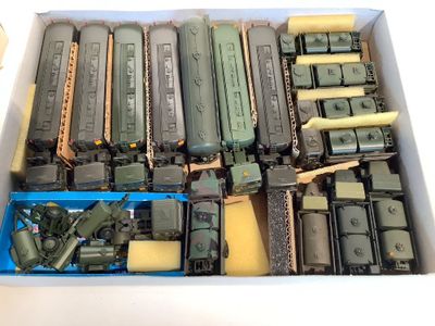a box full of toy army vehicles and other military items