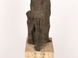 statue of a man and woman sitting on a stone block