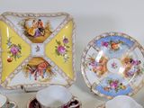 a lot of different plates and cups on the table
