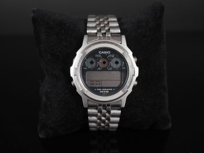 a close up of a watch on a black surface