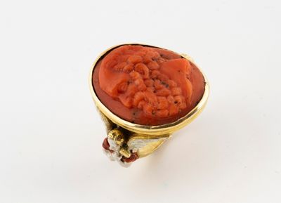 a close up of a ring with a red stone in it