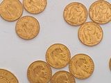 a lot of gold coins sitting on a white surface