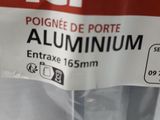 a bag of aluminum screws inside of a plastic container