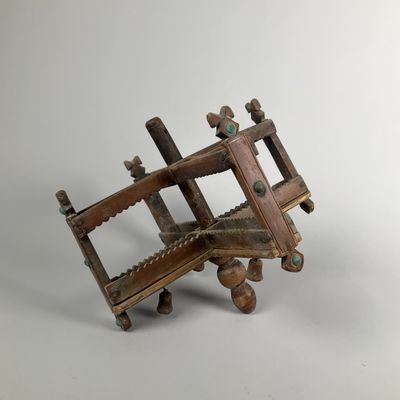 an old wooden model of a plane with wheels on a white background