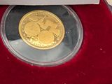 a gold coin sitting in a red box on a table