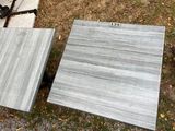 two pieces of marble sitting on the ground next to each other