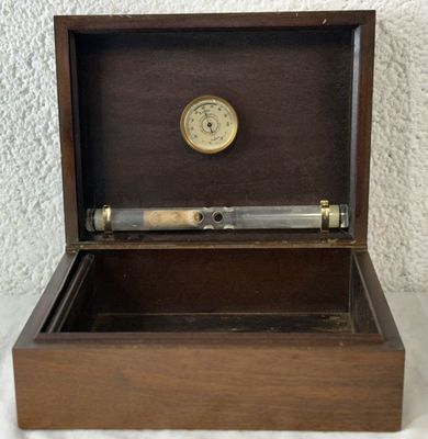 a wooden box with a clock inside of it