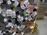 a large pile of rolls of paper with price tags on them