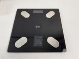 a black and white bathroom scale on a white table
