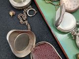 many different types of pocket watches on a tray