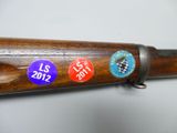 a close up of a rifle with a lot of buttons on it