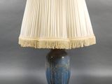 an image of a blue lamp with a white shade on it