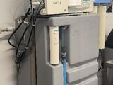 two chairs and a refrigerator in a room with tile flooring