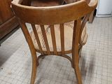 a wooden chair that is sitting in the corner of a room