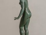 bronze statue of a woman standing on a black base