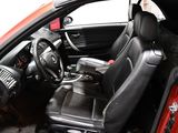 a red car with black leather seats and a steering wheel