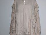 an image of a woman ' s blouse on a mannequin stand