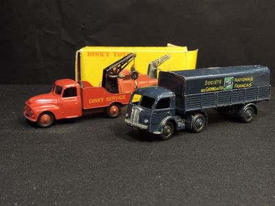 two toy trucks that are sitting next to each other