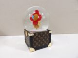 a snow globe with a teddy bear inside of it