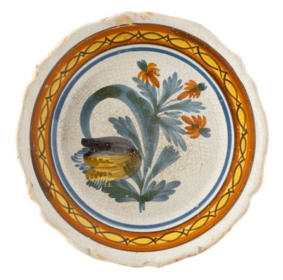 a plate with a bird on it and a flower in the middle