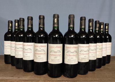 six bottles of red wine lined up on a wooden table