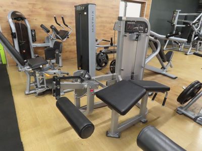 a gym room with a variety of machines in it