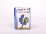a close up of a blue book with a rooster on it