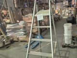a ladder that is sitting in the middle of a warehouse