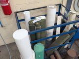 many rolls of paper on a cart next to a fire extinguisor
