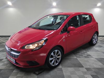 a red car parked in a garage with a checkered floor